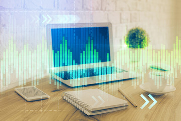 Forex market graph hologram and personal computer on background. Double exposure. Concept of investment.