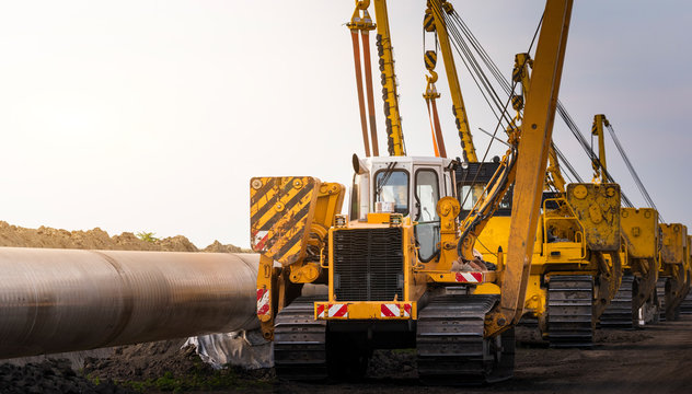 Crane digging a channel for gas pipeline