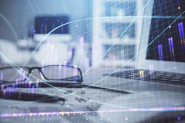 Financial chart hologram with glasses on the table background. Concept of business. Double exposure.