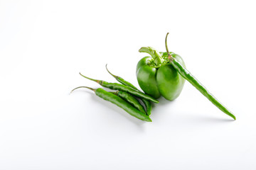 Fresh capsicum and green chili on white background 