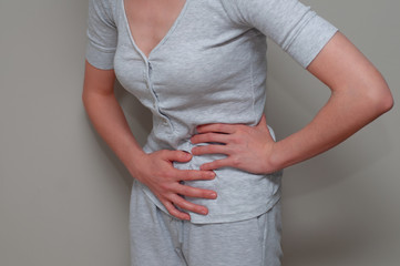 Young woman in pain, suffering from stomachache