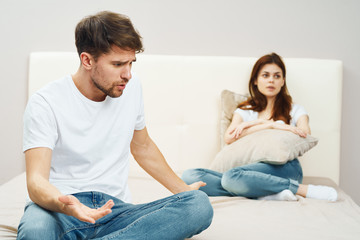 young couple sitting on sofa watching tv