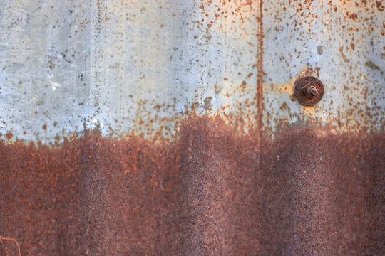 Metallic blue rust metal with a bolt