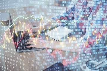 Multi exposure of forex graph with man working on computer on background. Concept of market analysis.