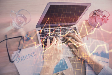 Multi exposure of forex graph with man working on computer on background. Concept of market analysis.