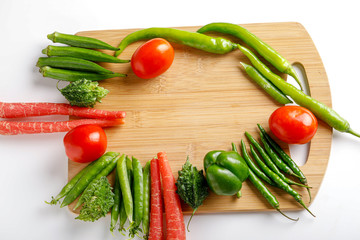 Raw vegetable on wooden board with copy space  