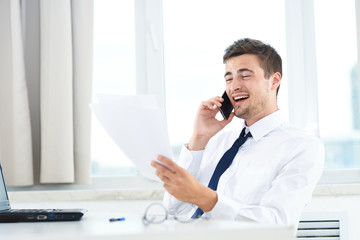 businessman talking on phone in his office