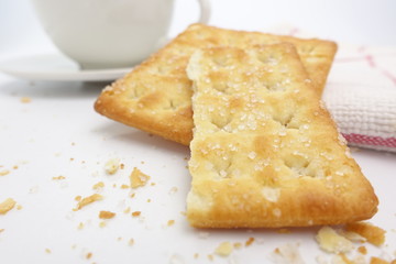 Cracker with coffee cup on white background