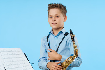 portrait of a boy with headphones on blue background