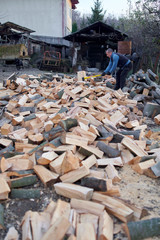 Man splitting wood with axe and maul