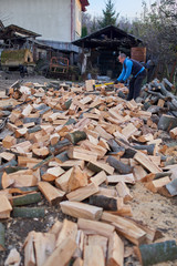 Man splitting wood with axe and maul
