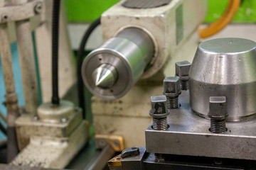 Side view of the tool holder and the tailstock of the lathe closeup.