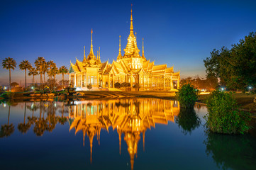 Fototapeta premium Buddhist temple with reflection on water landmark of Nakhon Ratchasima Province, Thailand.
