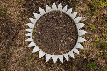 Empty flowerbed with soil on ground top view