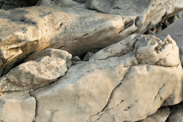 Detail of natural rough stone, rippled rock background