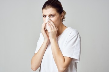 portrait of a woman blowing her nose