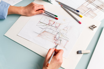 Interior designer drawing pencil sketch of a kitchen