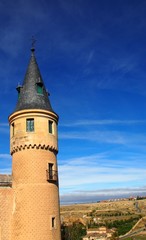 Fototapeta na wymiar Tower of the famous Alcazar in Segovia, Spain, with the wide open plain in the background