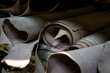Rolls of genuine leather in the workshop. Convolutions of vegetable tanned leather.