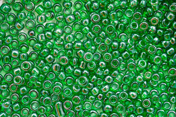 Bright green beads for making jewelry shot large on a white background