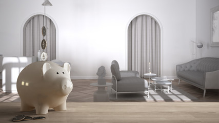 Wooden table top or shelf with white piggy bank with coins, classic white kitchen and living room, expensive home interior design, renovation restructuring concept architecture