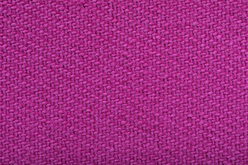 twill weaving fabric, pink stitches as pattern, tissue structure closeup.