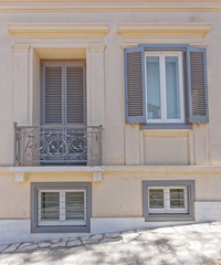 light ocher colored house front with grey windows, Athens Greece, Plaka neighborhood