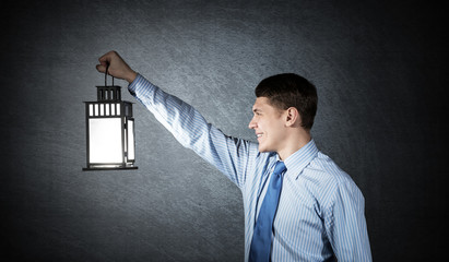 Happy businessman holding glowing lantern © adam121