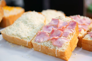 raw and fresh ham cheese bread or toast on white table for dessert or snack on breakfast for lunch and fastfood in cafe restaurant and coffee shop or street bakery