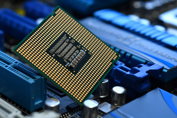 Detail of CPU Chip over socket of a modern computer motherboard. Electronic small component details. Selective Focus.