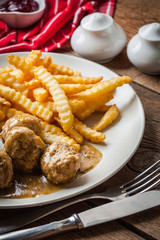 Meatballs with french fries in dill sauce.