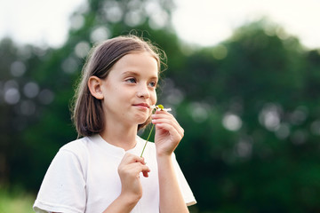 young woman blowing bubbles in the park