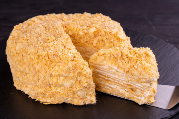 Cake napoleon with cut piece with cream layer