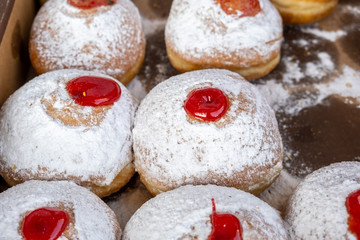 Obraz na płótnie Canvas Fresh tasty donuts with jam for Hanukkah celebration sold at the local farmers market