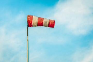 Fraying windsock against the blue sky