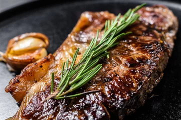 Foto op Canvas Beef New York strip steak on black background. Space for text. Marble premium beef. Close up. © Vladimir