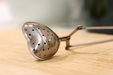 Tea strainer on a wooden board
