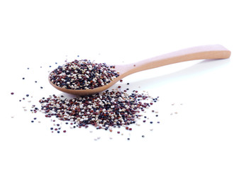Quinoa in wooden spoon on white