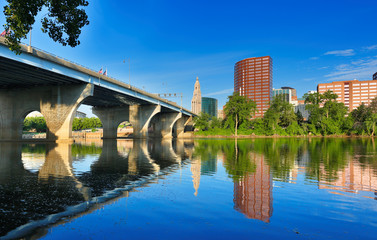 The skyline of Hartford, Connecticut at sunrise. Photo shows Founders Bridge and Connecticut River. Hartford is the capital of Connecticut. 