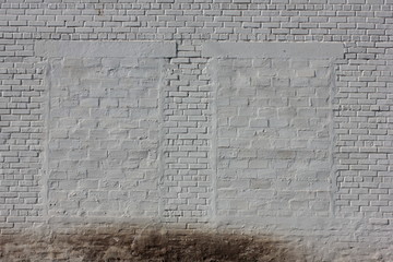 Bricked windows on a white wall. White background with old brick wall and bricked windows. Windows laid with white bricks in a large brick wall. No exit