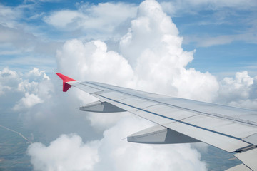 Fototapeta na wymiar Look through the plane window and white cloud and blue sky