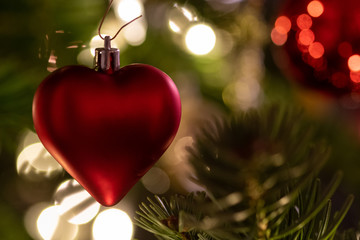 a red heart as christmas decoration on the christmas  tree 1