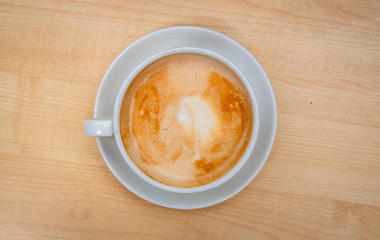 Top view cup of coffee placed on a wooden table
