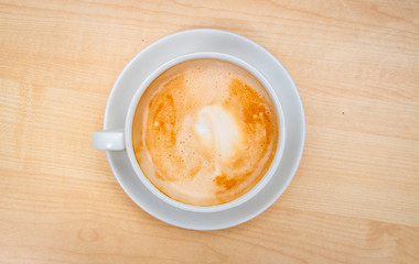 Top view cup of coffee placed on a wooden table
