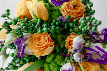 A bouquet of yellow roses with green balls