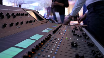 DJ control music console and colorful light in nightclub. DJ mixer player and sound console for disco party. Disc jockey panel and mixing deck with colored illuminated