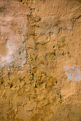 Vertical shabby old yellow wall surface