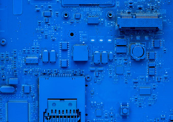 Computer motherboard. Classic blue background with pc backdrop, close up. Single color microchip