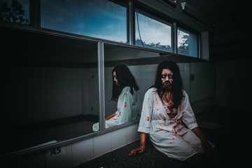 Portrait of asian woman make up ghost face with blood,Horror scene,Scary background,Halloween...