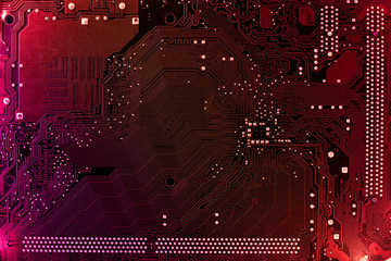 Computer motherboard background with blur neon multicolor glow, pc backdrop, close up